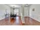 Bright dining room with hardwood floors, wainscoting, and plantation shutters on windows at 337 Inverness Ave, Mcdonough, GA 30253