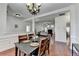 Open-concept dining area with hardwood floors and view into adjacent living room at 337 Inverness Ave, Mcdonough, GA 30253