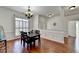 Open dining area with wood floors, decorative wainscoting and a view of the entryway at 337 Inverness Ave, Mcdonough, GA 30253