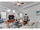 Spacious living room with hardwood floors, brick fireplace, and a ceiling fan at 337 Inverness Ave, Mcdonough, GA 30253