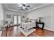 Large main bedroom with tray ceiling, hardwood floors, and a door to the outside at 337 Inverness Ave, Mcdonough, GA 30253