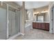 Bright bathroom featuring a glass shower door, soaking tub and double sink vanity with neutral tile floor at 971 Reap Ln, Lawrenceville, GA 30043