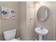 Stylish half-bath features a pedestal sink and decorative mirror at 971 Reap Ln, Lawrenceville, GA 30043