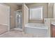 This bathroom offers a separate shower and tub plus a window over the tub, offering natural light at 971 Reap Ln, Lawrenceville, GA 30043