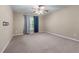 A carpeted bedroom with a ceiling fan and two-toned curtains allows lots of natural light at 971 Reap Ln, Lawrenceville, GA 30043