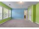 Spacious carpeted bedroom with ensuite bathroom; light pouring from the windows at 971 Reap Ln, Lawrenceville, GA 30043