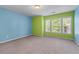 Bright bedroom with blue and green walls and three large windows at 971 Reap Ln, Lawrenceville, GA 30043