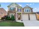 Beautiful two-story home with a manicured lawn and a two-car garage at 971 Reap Ln, Lawrenceville, GA 30043