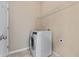 Cozy laundry room with a modern washer and wire shelving, offering practical storage solutions at 971 Reap Ln, Lawrenceville, GA 30043