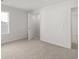 Bright bedroom featuring neutral carpeting, a window, and an open closet at 2717 Montie Ct, Lithia Springs, GA 30122