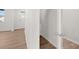 Hallway featuring wood-look floors, white walls, and doorways leading to other rooms in the house at 2717 Montie Ct, Lithia Springs, GA 30122