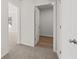 Hallway view with white trim and white doors, showing the seamless flow to rooms with wood-look flooring at 2717 Montie Ct, Lithia Springs, GA 30122
