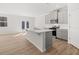 Modern kitchen with a large center island, gray cabinets, stainless steel appliances, and wood floors at 2717 Montie Ct, Lithia Springs, GA 30122