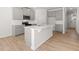 Modern kitchen with a large center island, gray cabinets, stainless steel appliances, and wood floors at 2717 Montie Ct, Lithia Springs, GA 30122
