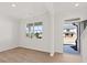 Bright and airy living room featuring clean white walls, wood-look flooring, and a large window at 2717 Montie Ct, Lithia Springs, GA 30122