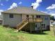 Exterior rear view showcasing the deck, stairs, and fenced-in yard at 493 Kyles Cir, Hiram, GA 30141