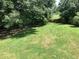 Picturesque backyard with lush green grass and mature trees, perfect for outdoor activities at 493 Kyles Cir, Hiram, GA 30141