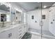 Updated bathroom featuring double vanity, modern tile shower, and glass shower door at 11352 Musette Cir, Alpharetta, GA 30009
