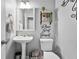 Charming powder room with pedestal sink, decorative mirror, and stylish wall decor, creating a cozy ambiance at 11352 Musette Cir, Alpharetta, GA 30009