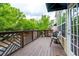 Relaxing deck with wood floor and railing, offering a serene outdoor space, and a nice exterior door at 11352 Musette Cir, Alpharetta, GA 30009