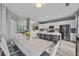 Open-concept kitchen featuring white cabinets, stainless steel appliances, large island with seating, and modern lighting at 11352 Musette Cir, Alpharetta, GA 30009