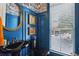 Stylish powder room featuring blue walls, a unique sink, and elegant decor at 2442 Crescent Park Ct, Atlanta, GA 30339