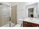 Bathroom featuring a shower, white commode, and a dark vanity with white countertops at 2442 Crescent Park Ct, Atlanta, GA 30339
