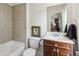 Traditional bathroom with tiled tub, dark wood vanity, and neutral wall paint at 2442 Crescent Park Ct, Atlanta, GA 30339
