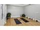 Bonus room features hardwood floors, plants, two yoga mats, and recessed ceiling at 2442 Crescent Park Ct, Atlanta, GA 30339