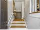 Inviting entryway featuring hardwood steps with white risers and a decorative table with flower arrangement at 2442 Crescent Park Ct, Atlanta, GA 30339