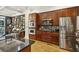 Modern kitchen featuring stainless steel appliances, dark cabinets, and view of the living room at 2442 Crescent Park Ct, Atlanta, GA 30339