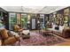 Stylish living room with dark walls, large windows, and a chandelier over a red patterned rug at 2442 Crescent Park Ct, Atlanta, GA 30339