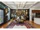 Spacious living room with hardwood floors, coffered ceiling, view of the kitchen and dark walls at 2442 Crescent Park Ct, Atlanta, GA 30339