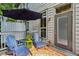 Outdoor patio with blue Adirondack chairs, an orange rug, and an umbrella for shade at 2442 Crescent Park Ct, Atlanta, GA 30339