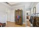 Walk-in closet with an armoire with ample storage and convenient access to the bathroom at 2442 Crescent Park Ct, Atlanta, GA 30339