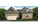 Charming single-story brick home featuring an attached garage and meticulously landscaped front yard at 109 Crooked Lake Park, Villa Rica, GA 30180