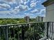 Enjoy city views from the balcony, with a decorative railing overlooking lush trees and buildings under a cloudy sky at 199 14Th Street Ne St # 704, Atlanta, GA 30309