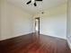 Spacious bedroom featuring ceiling fan, and hardwood flooring with a doorway at 199 14Th Street Ne St # 704, Atlanta, GA 30309