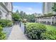 Beautiful courtyard featuring manicured gardens, a pergola covered outdoor dining area, and lush greenery at 199 14Th Street Ne St # 704, Atlanta, GA 30309