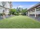 Expansive manicured lawn and courtyard, complemented by mature trees and a covered outdoor kitchen and dining area at 199 14Th Street Ne St # 704, Atlanta, GA 30309