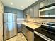 Well-lit kitchen featuring stainless steel appliances and stylish countertops at 199 14Th Street Ne St # 704, Atlanta, GA 30309