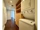 Efficient laundry area featuring a stacked washer and dryer, complemented by built-in shelving and drawers at 199 14Th Street Ne St # 704, Atlanta, GA 30309