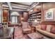Elegant library with custom wood bookcases, coffered ceilings, a window seat and a plush seating area at 199 14Th Street Ne St # 704, Atlanta, GA 30309