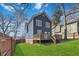 Beautiful backyard with a large deck, lush green grass, and privacy fence at 2395 Saint James Nw Dr, Atlanta, GA 30318