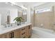 Modern bathroom with double sink vanity, soaking tub, and decorative plants, exuding a spa-like ambiance at 2395 Saint James Nw Dr, Atlanta, GA 30318