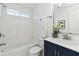 Bright bathroom with white subway tile in the shower, a navy blue vanity, and modern fixtures at 2395 Saint James Nw Dr, Atlanta, GA 30318
