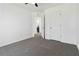 This bedroom has neutral carpet, white walls and trim, and white doors at 2395 Saint James Nw Dr, Atlanta, GA 30318