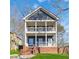 Charming two-story home with a double front porch, brick foundation, and nicely manicured lawn at 2395 Saint James Nw Dr, Atlanta, GA 30318