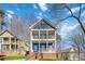 Charming two-story home featuring a double front porch, brick foundation, and beautifully maintained lawn at 2395 Saint James Nw Dr, Atlanta, GA 30318