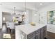 Open layout showcases a kitchen with island seating and seamless flow into other areas of the home at 2395 Saint James Nw Dr, Atlanta, GA 30318